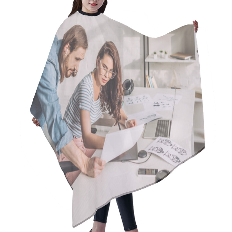 Personality  Illustrator Holding Sketch Near Coworker In Glasses  Hair Cutting Cape