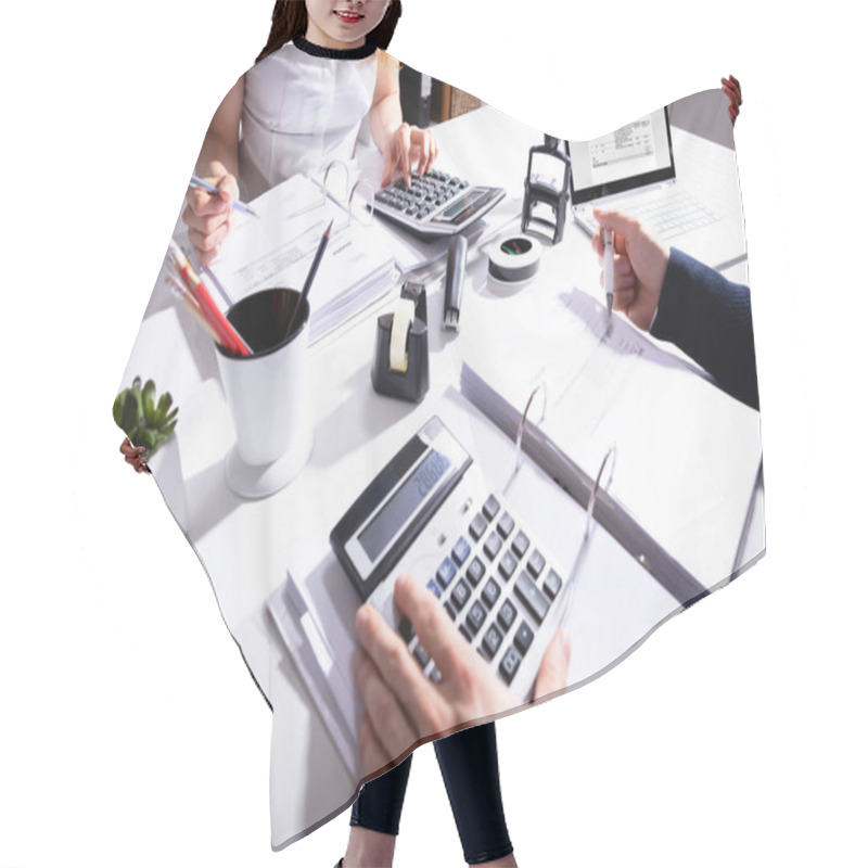 Personality  Elevated View Of Two Businesspeople Calculating Invoice With Calculator At Workplace Hair Cutting Cape