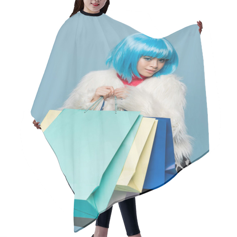 Personality  Young Asian Woman In Bright Wig Holding Shopping Bags Isolated On Blue  Hair Cutting Cape