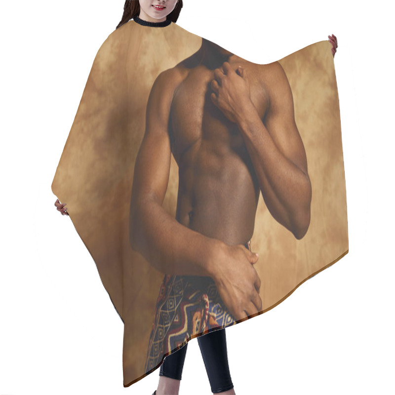 Personality  A Young African American Man Stands Confidently, Posing Topless. He Highlights His Well Defined Physique While Draped Elegantly In Patterned Fabric, Against A Textured Background. Hair Cutting Cape