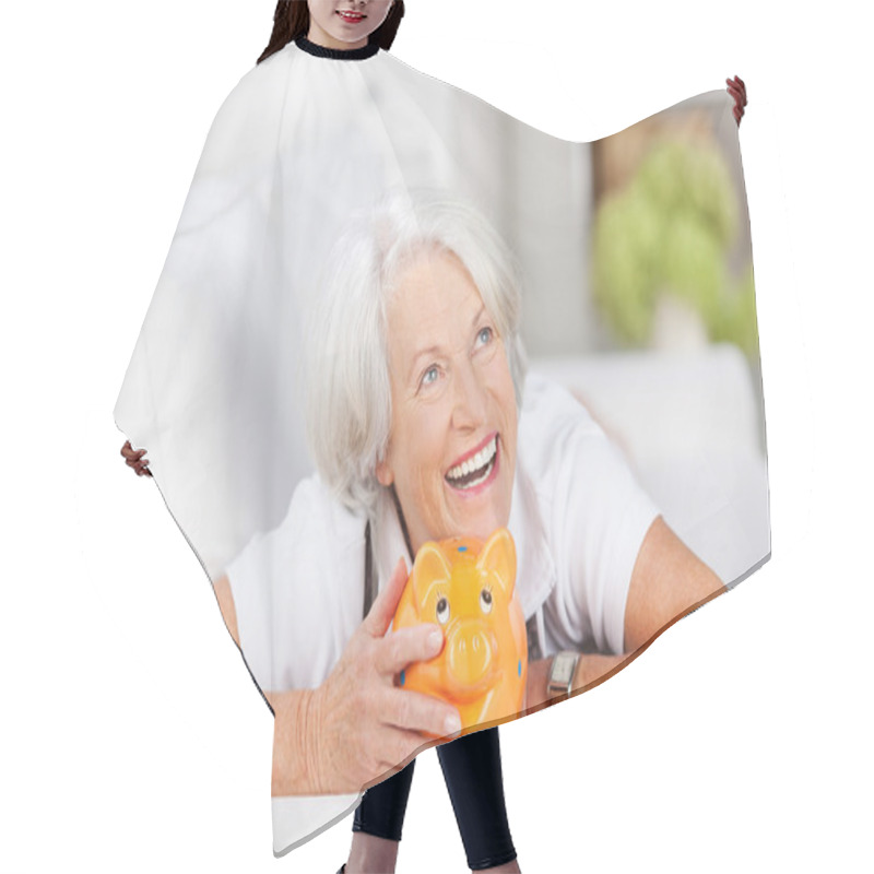 Personality  Smiling Senior Woman With A Piggy Bank Hair Cutting Cape