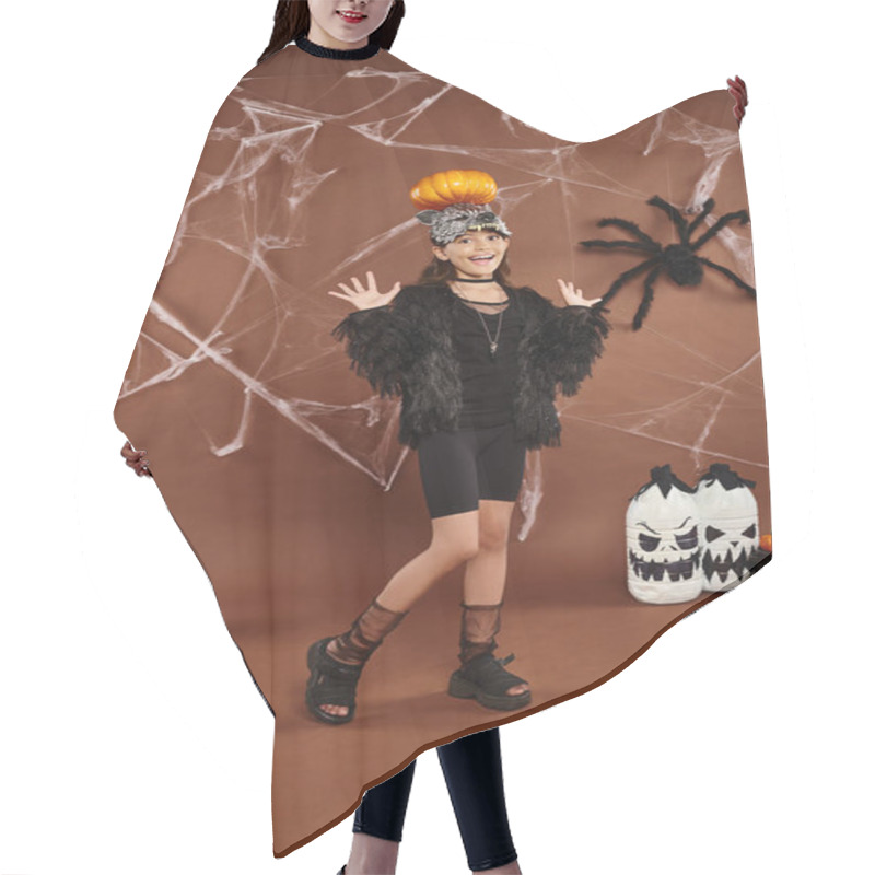 Personality  Preteen Girl Holding Pumpkin On Her Head With Raised Hands, Brown Backdrop With Web, Halloween Hair Cutting Cape