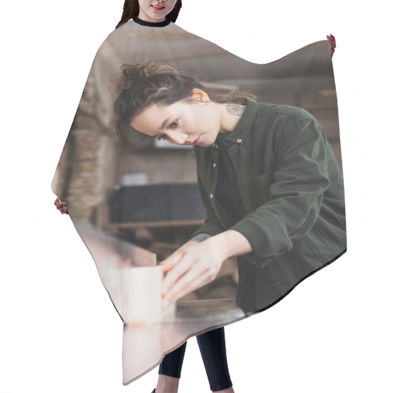 Personality  Tattooed Furniture Designer Holding Blurred Plank Near Jointer Machine Hair Cutting Cape