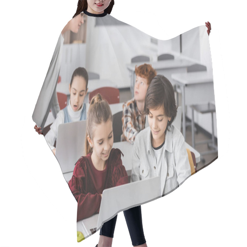 Personality  Teacher Standing Near Schoolkids Working On Laptops In Classroom Hair Cutting Cape