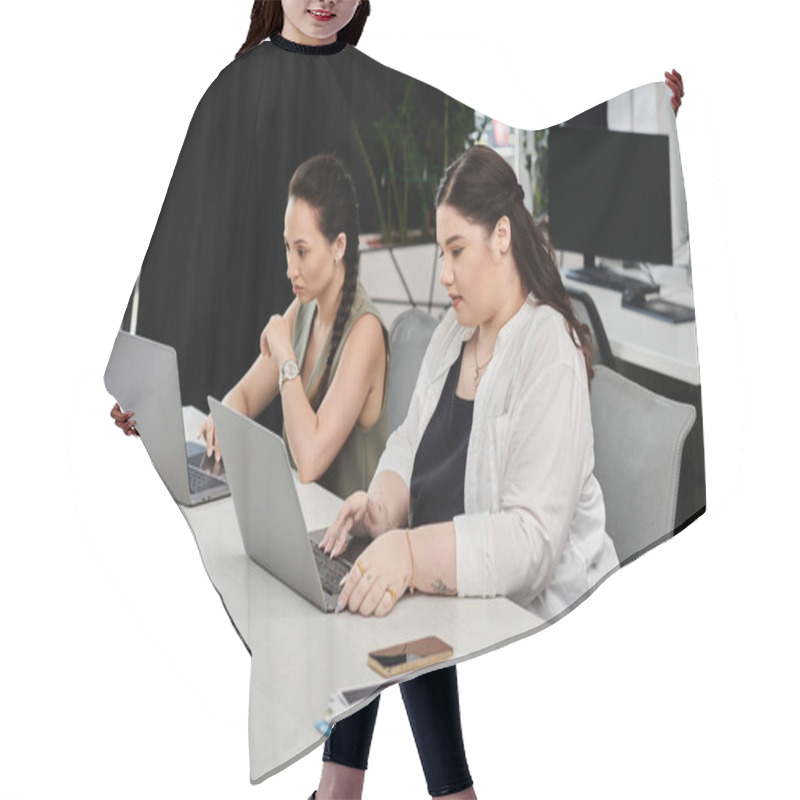 Personality  Two Professionals Focus On Their Laptops, Sharing Ideas In A Stylish Office Environment. Hair Cutting Cape