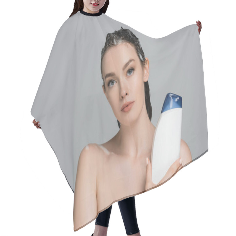 Personality  Brunette Young Woman With Wet Foamy Hair Holding Bottle With Shampoo Isolated On Grey  Hair Cutting Cape