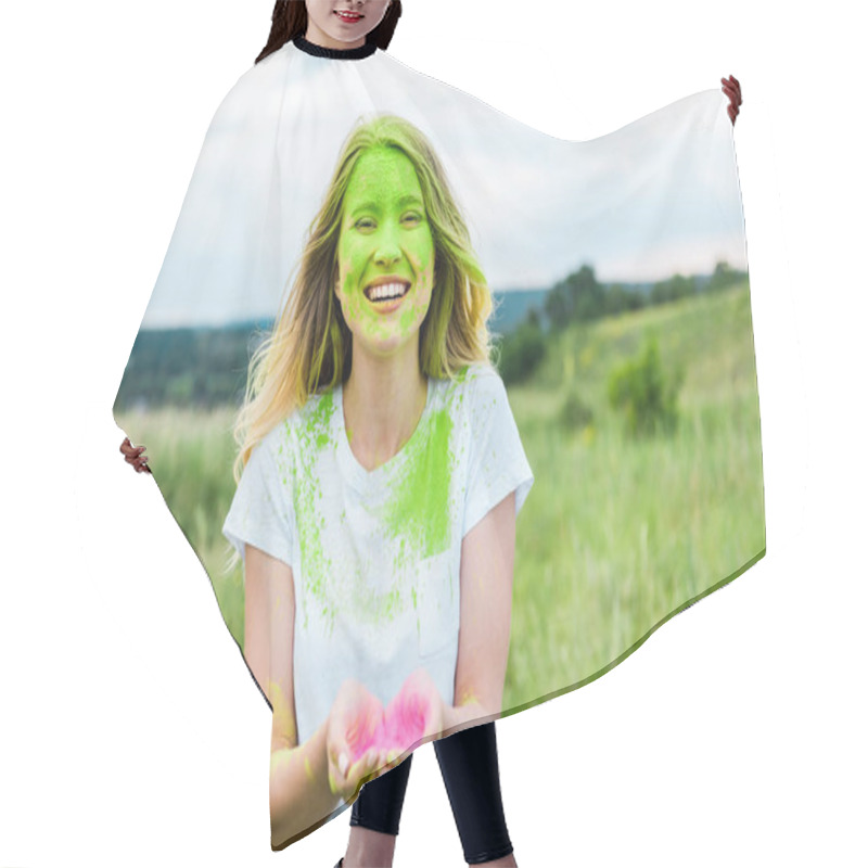 Personality  Cheerful Woman With Green Holi Paint On Face Standing With Cupped Hands And Smiling Outdoors  Hair Cutting Cape