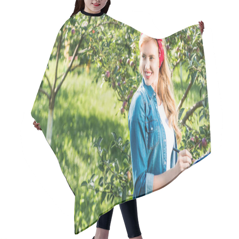 Personality  Smiling Farmer Holding Clipboard In Apple Garden At Farm And Looking Away  Hair Cutting Cape