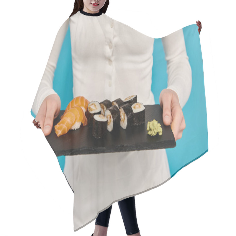 Personality  Cropped View Of Woman With Blonde Hair Holds A Tray Of Mouthwatering Sushi, Exuding Grace And Sophistication In A White Dress. Hair Cutting Cape