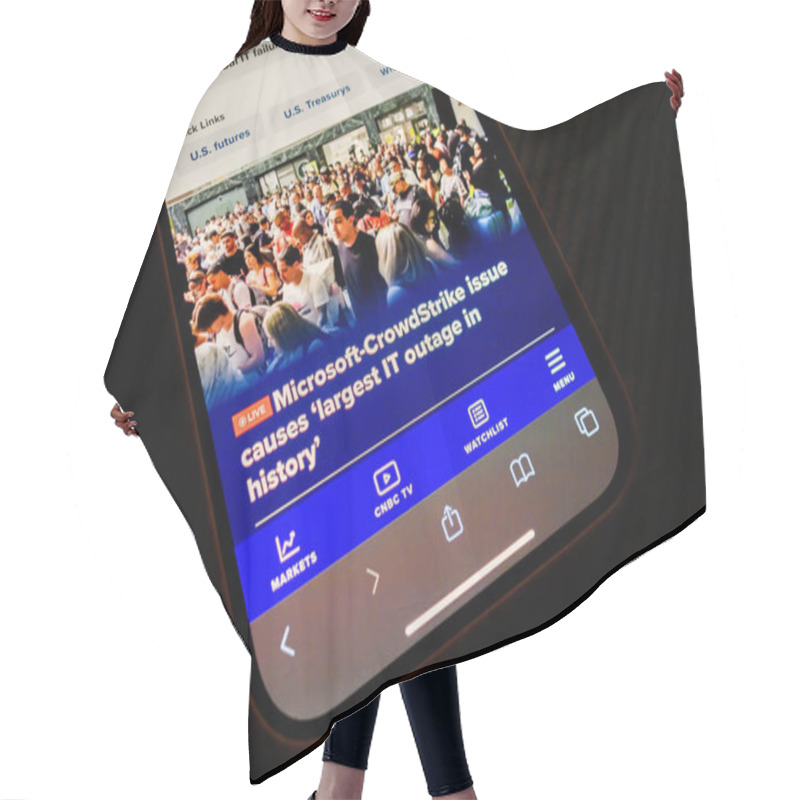 Personality  Paris, France - Jul 20, 2024: An IPhone Displays A CNBC Article About The Microsoft-CrowdStrike Issue Causing The Largest IT Outage In History, Showing A Crowd Of People Affected, With The Screen Hair Cutting Cape