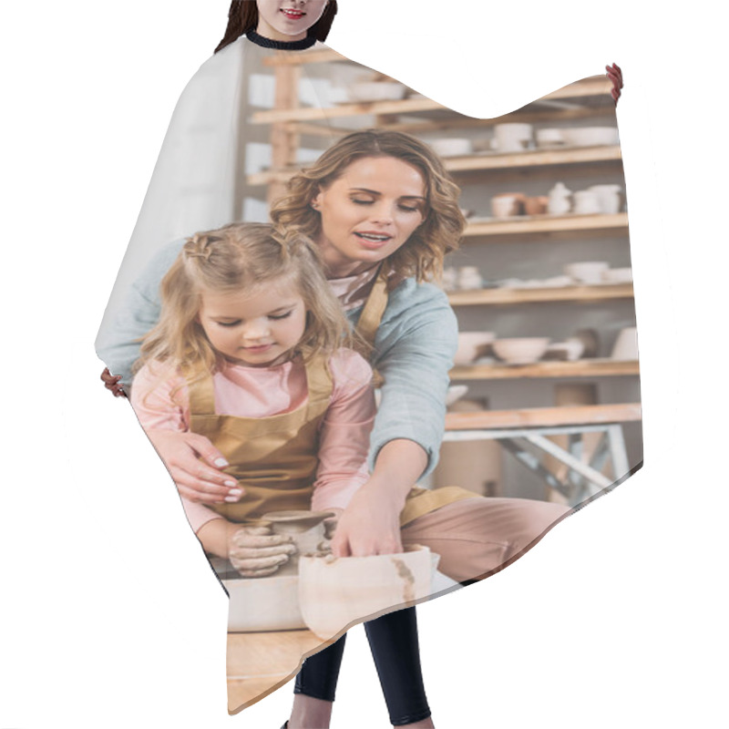 Personality  Mother And Daughter Making Ceramic Pot On Pottery Wheel Together Hair Cutting Cape