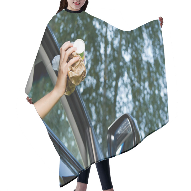 Personality  The Girl Is Going To Throw A Handful Of Garbage Accumulated In The Car Into The Open Window Of The Car. Bottom View, Against The Background Of Blurry Trees And Sky, Summer Day Hair Cutting Cape