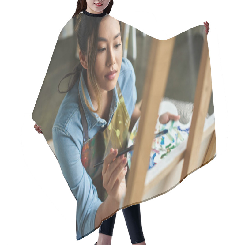 Personality  A Young Asian Artist, Wearing An Apron, Paints On A Canvas In Her Workshop. Hair Cutting Cape