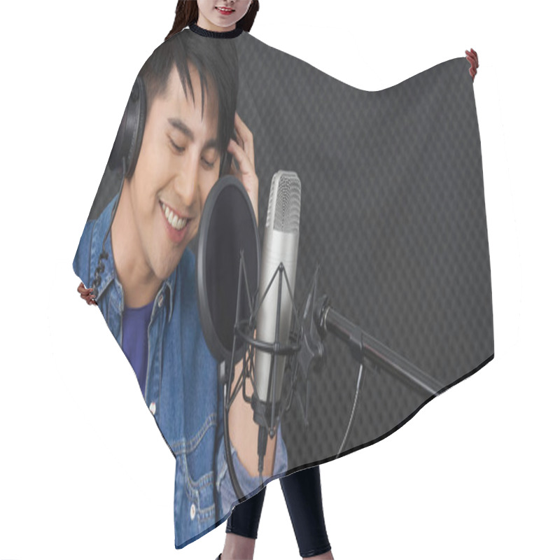 Personality  Musician Producing Music In Professional Recording Studio. Young Asian Man With Headphone Singing In Front Of Black Soundproof Wall. Hair Cutting Cape