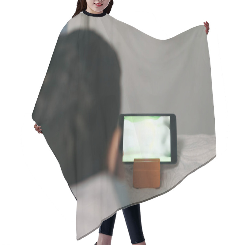 Personality  Back View Of Child Watching Educational Cartoon On Smartphone While Lying On Bed Hair Cutting Cape