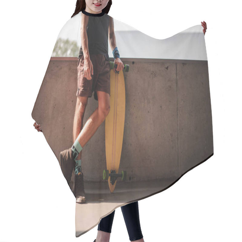 Personality  Young Man Standing Leaning On The Parapet And Holding A Longboard Hair Cutting Cape