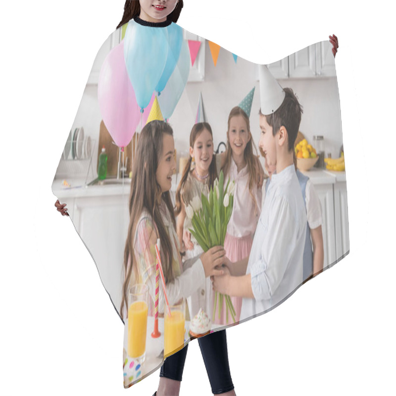 Personality  Happy Preteen Boy Giving Flowers To Cheerful Birthday Girl Near Friends During Party  Hair Cutting Cape