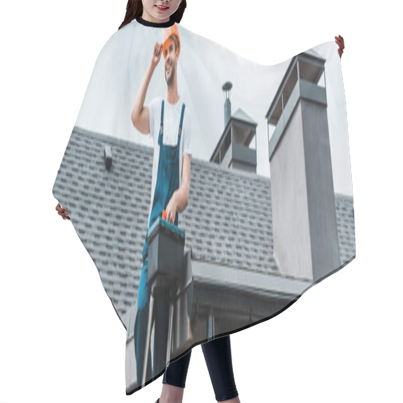 Personality  Panoramic Shot Of Happy Repairman Sitting On Roof And Holding Toolbox  Hair Cutting Cape