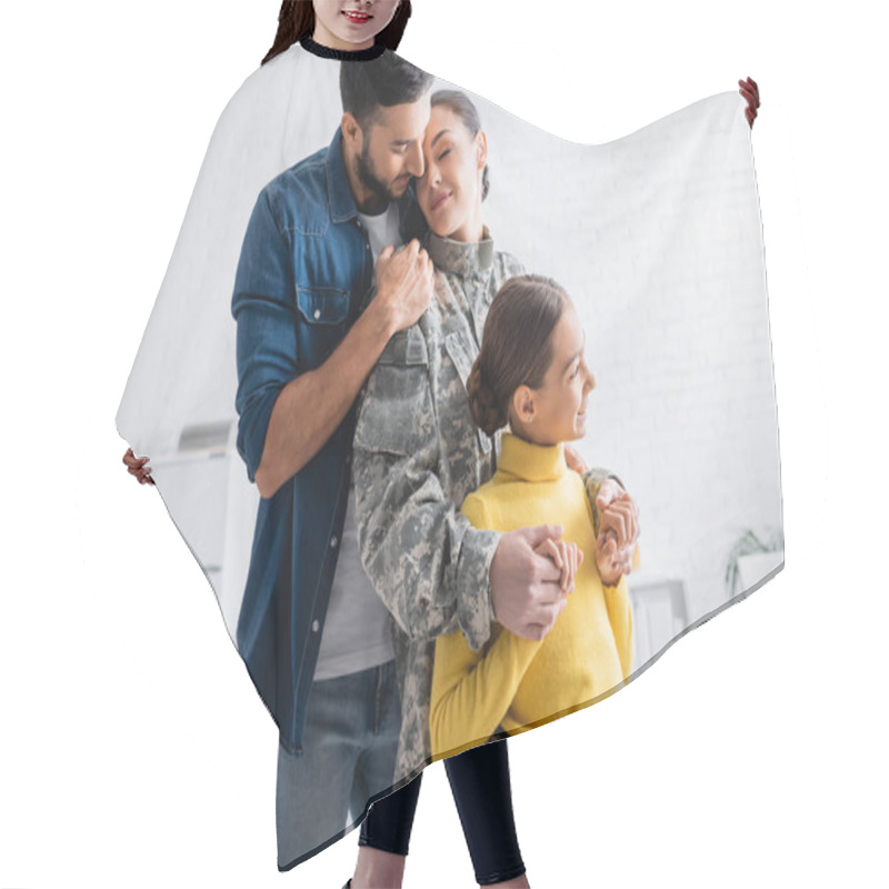 Personality  Smiling Child Holding Hands Of Mother In Military Uniform Near Dad At Home  Hair Cutting Cape