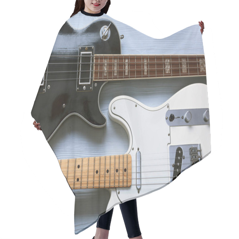 Personality  Two Guitars On A Light Wooden Board. Hair Cutting Cape