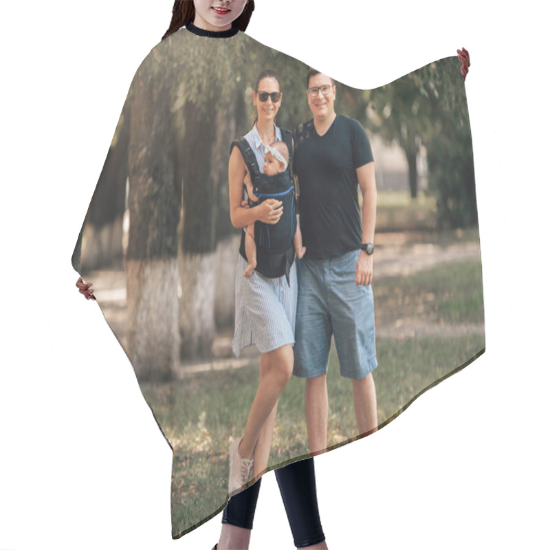 Personality  Family Day In The Park. Happy Young Couple With Newborn Baby. Mother Carry Baby In Ergonomic Baby Carrier Hair Cutting Cape