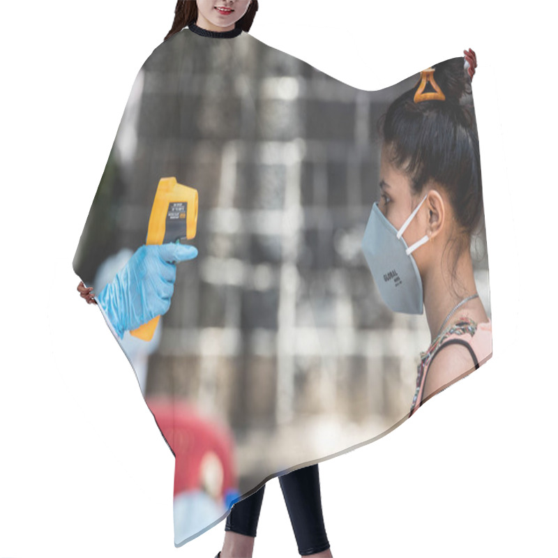 Personality  MUMBAI/INDIA- JUNE 10, 2020: A Medical Personnel  Wearing Protective Gear Monitor People Body Temperature At A COVID Test Drive, Dharavi During The COVID-19 Coronavirus Pandemic Hair Cutting Cape