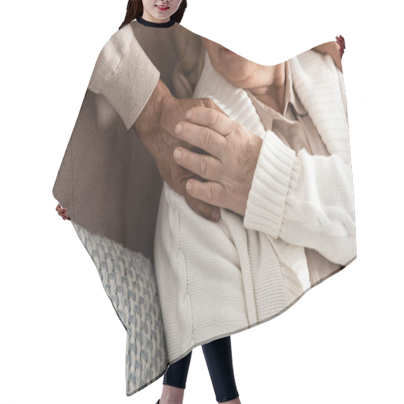 Personality  Cropped View Of Senior Woman Touching Hand On Husband  Hair Cutting Cape