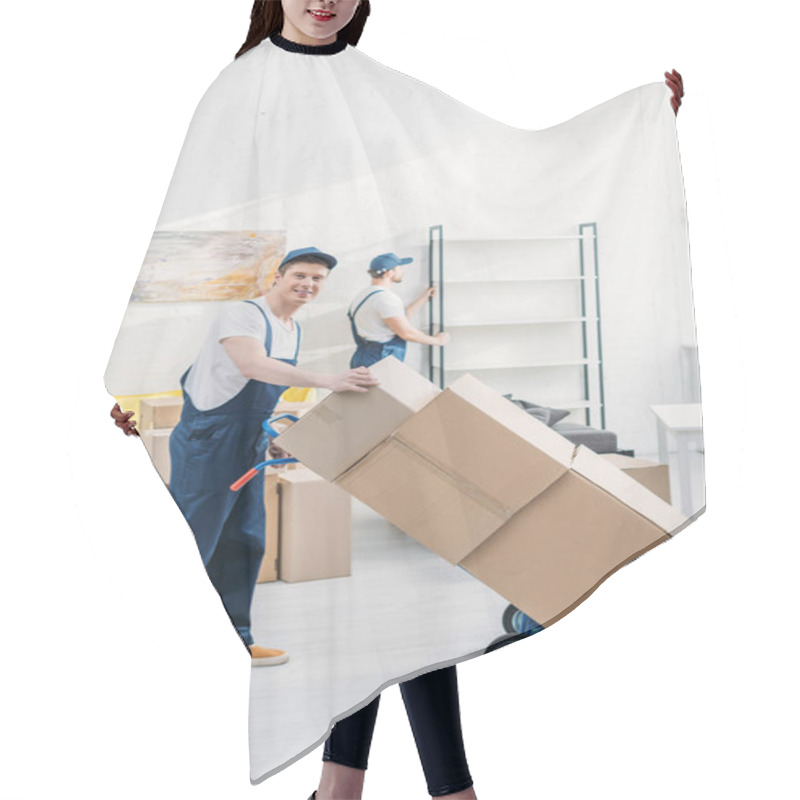 Personality  Two Movers In Uniform Transporting Cardboard Boxes And Furniture In Apartment Hair Cutting Cape