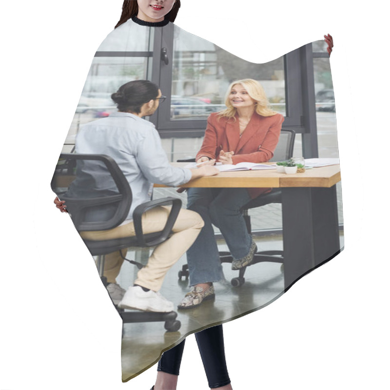 Personality  Attractive Woman Engages In Conversation With A Man During Job Interview. Hair Cutting Cape