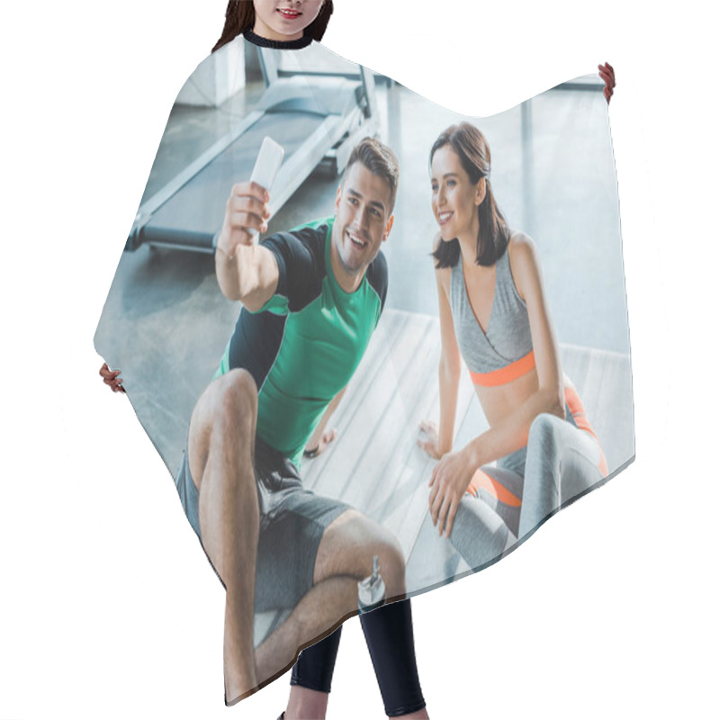 Personality  Sportsman Taking Selfie With Smiling Sportswoman In Sports Center Hair Cutting Cape