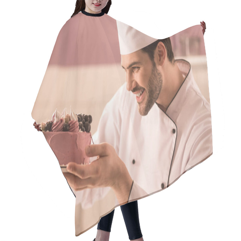 Personality  Side View Of Smiling Confectioner Looking At Cake In Hands In Restaurant Kitchen Hair Cutting Cape