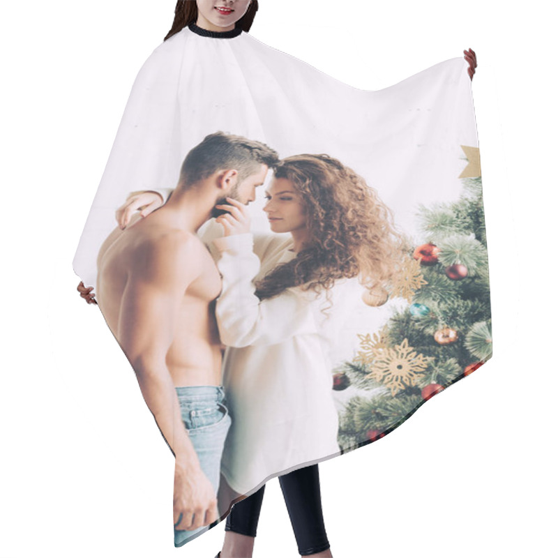 Personality  Cheerful Young Woman Embracing Shirtless Boyfriend Near Christmas Tree At Home Hair Cutting Cape