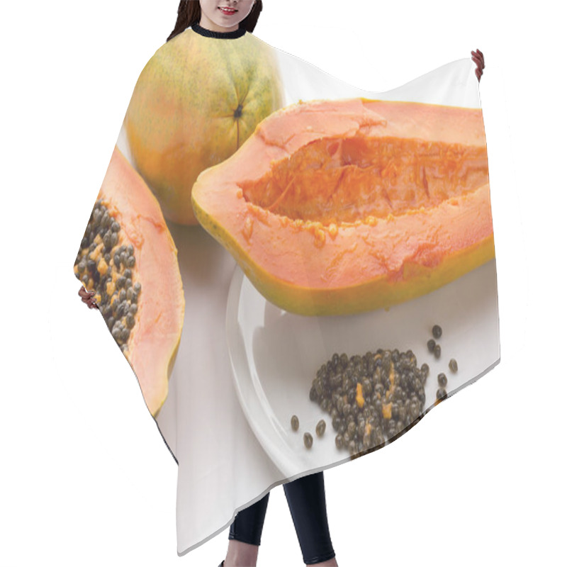 Personality  Hollowed Out Half Of A Raw Papaya In Longitudinal Cross Section And Its Countless Peppery Seeds On A White Plate. Succulent Breakfast Fruit Of The Tropical Carica Papaya. Close Up. White Background. Hair Cutting Cape