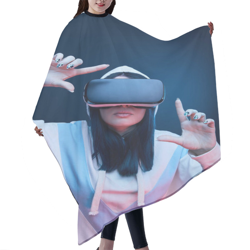 Personality  Brunette Woman In Hood Gesturing And Wearing Virtual Reality Headset On Blue Hair Cutting Cape