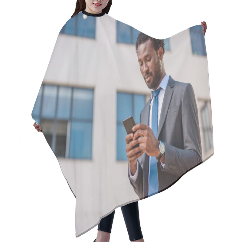 Personality  Handsome, Attentive African American Businessman In Suit Using Smartphone Hair Cutting Cape