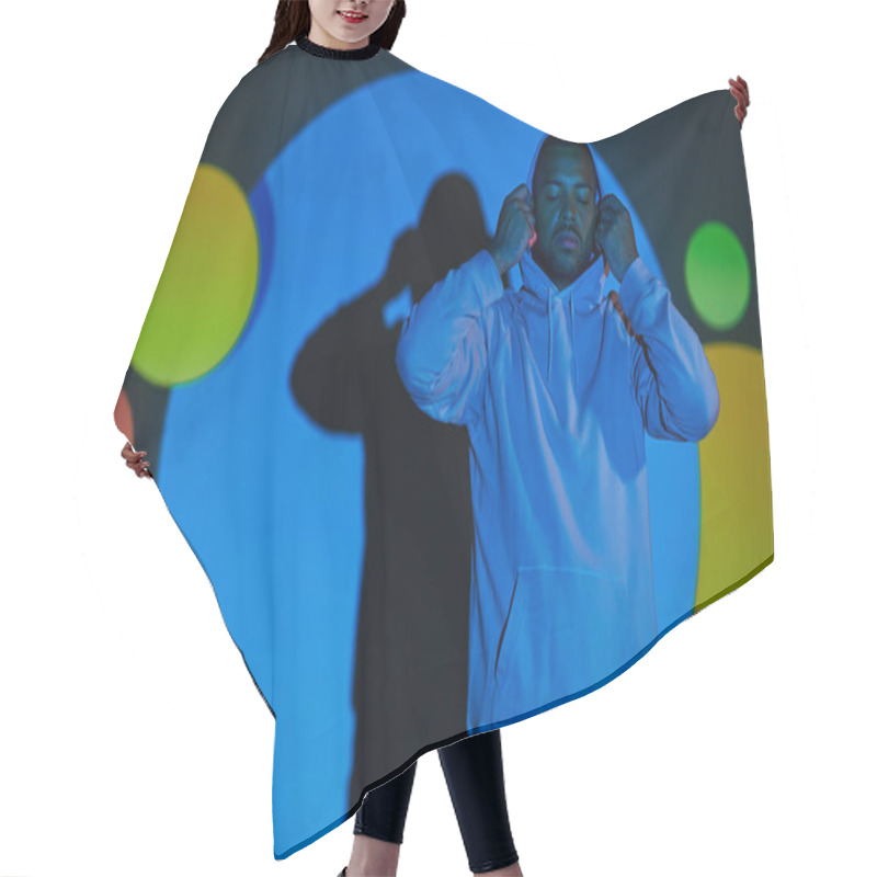 Personality  Handsome Man Putting On Hood With Closed Eyes In Digital Projector Lights, Fashion Concept Hair Cutting Cape