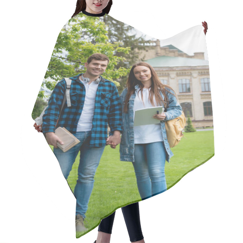 Personality  Cheerful Students Holding Hands While Standing On Grass Near University Campus  Hair Cutting Cape