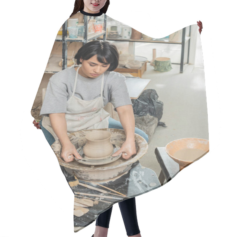 Personality  Young Asian Female Ceramicist In Apron Shaping Clay Vase With Tools On Spinning Pottery Wheel Near Sponge And Bowl With Water In Ceramic Studio, Artisanal Pottery Production And Process Hair Cutting Cape