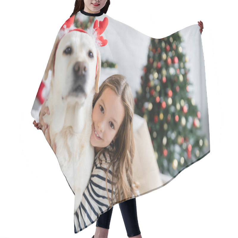 Personality  Smiling Girl Hugging Labrador With Christmas Headband And Looking At Camera In Living Room  Hair Cutting Cape