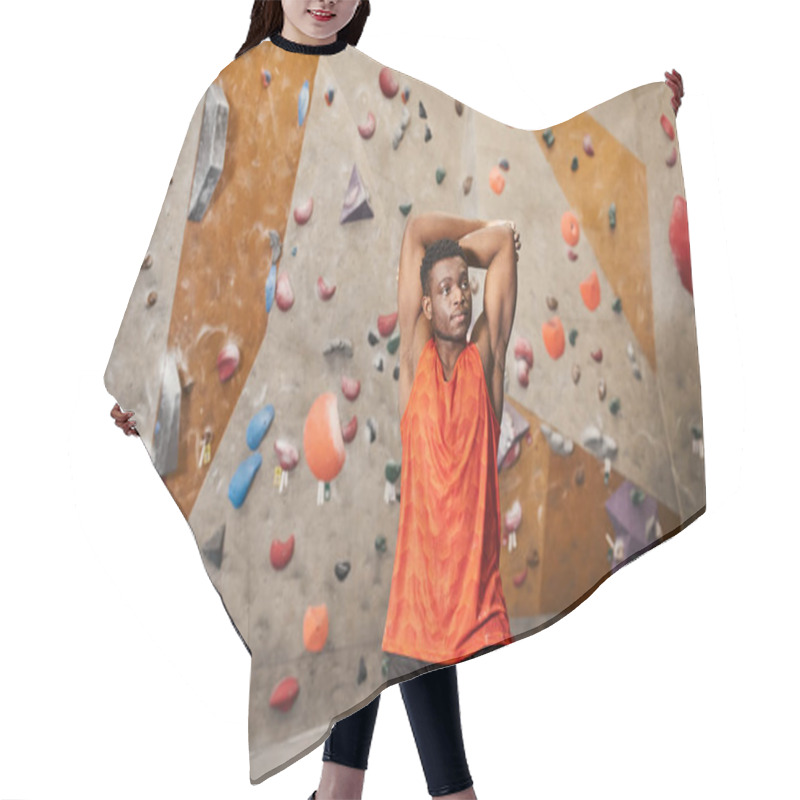 Personality  Sporty African American Man With Hands Behind Head Looking Away With Climbing Wall On Backdrop Hair Cutting Cape