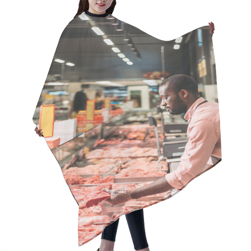 Personality  Focused African American Male Butcher In Apron Taking Steak Of Raw Meat In Supermarket  Hair Cutting Cape