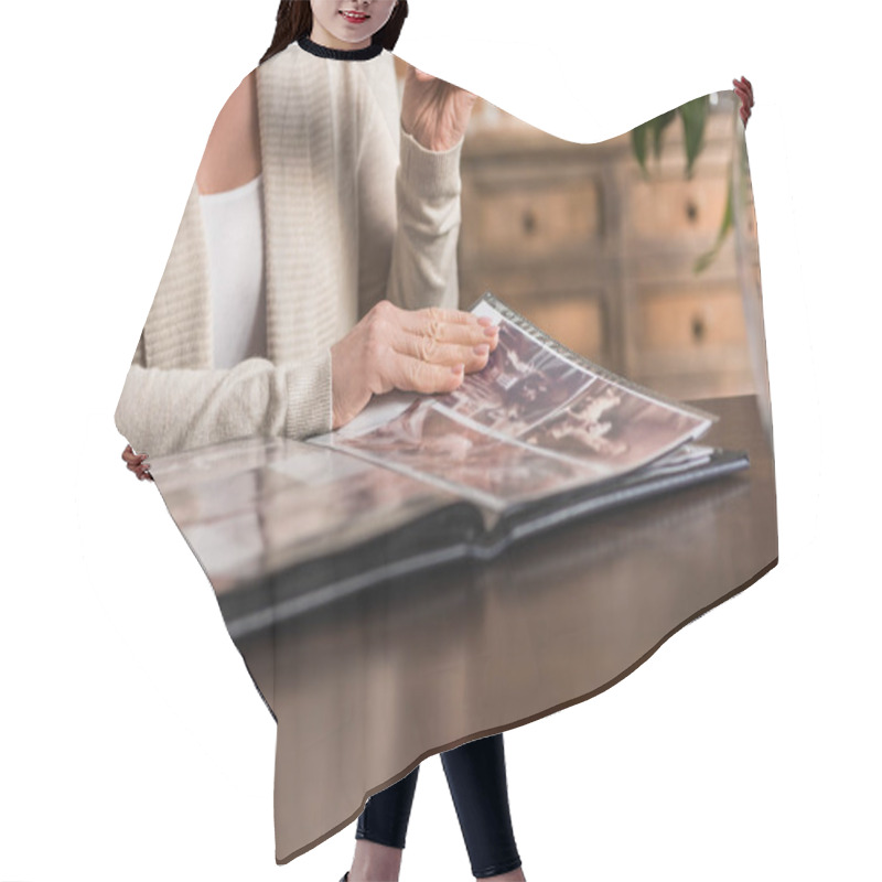 Personality  Senior Woman Looking At Photo Album Hair Cutting Cape