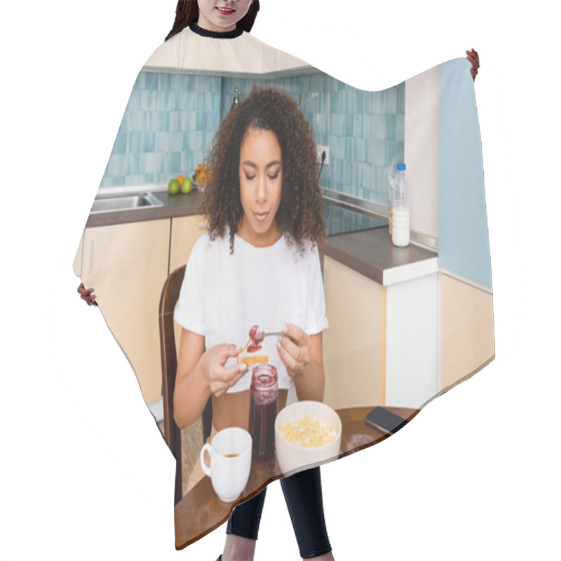 Personality  Attractive African American Woman Holding Spoon With Sweet Jam Near Toast Bread And Smartphone With Blank Screen  Hair Cutting Cape