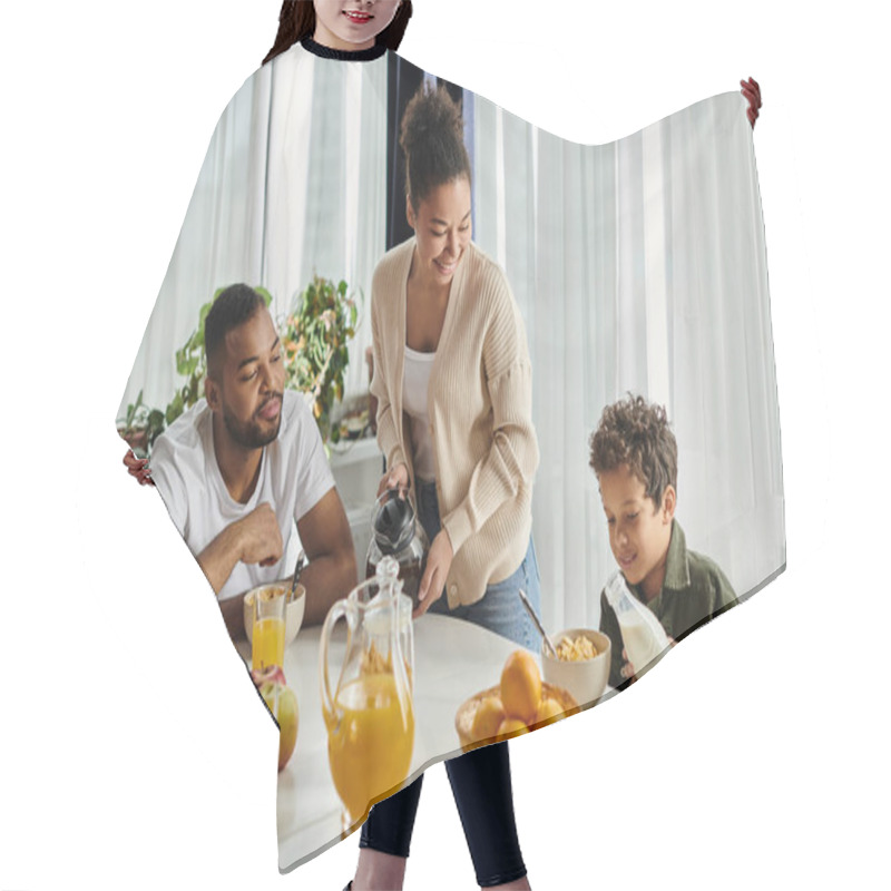 Personality  Parents And Boy Sitting At Table With Pitcher Of Orange Juice. Hair Cutting Cape