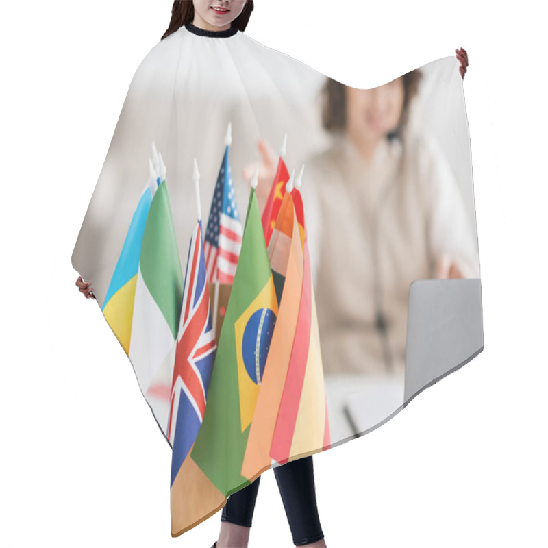 Personality  Selective Focus Of Various International Flags Near Blurred Laptop And Language Teacher Having Online Lesson At Home Hair Cutting Cape