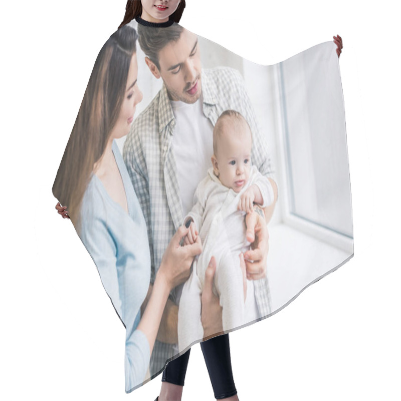 Personality  Portrait Of Young Parents With Baby At Home Hair Cutting Cape