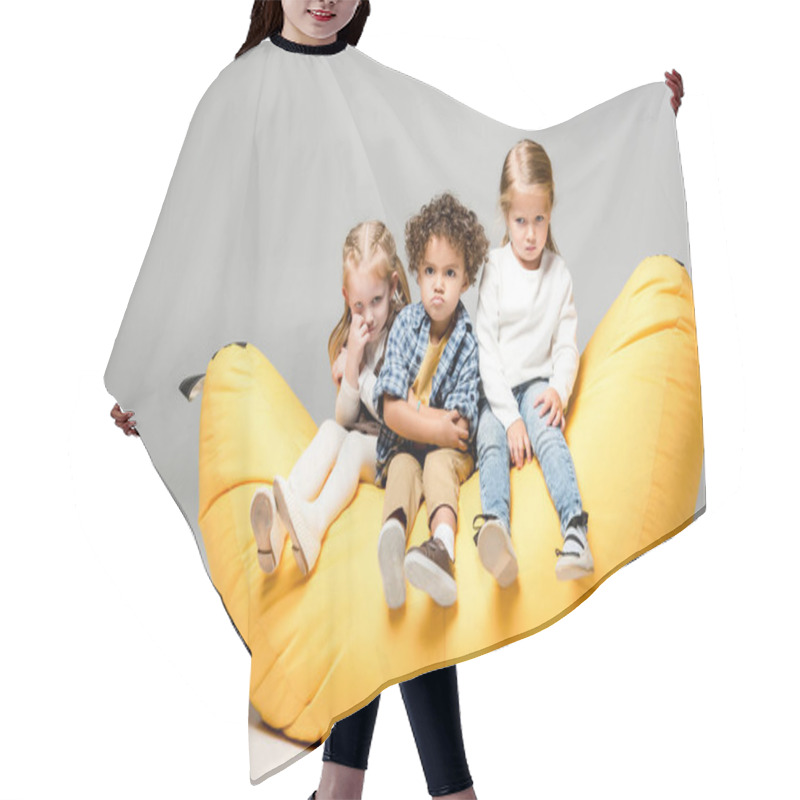 Personality  Offended Multicultural Kids Sitting On Yellow Bin Bag Chair On Grey Hair Cutting Cape