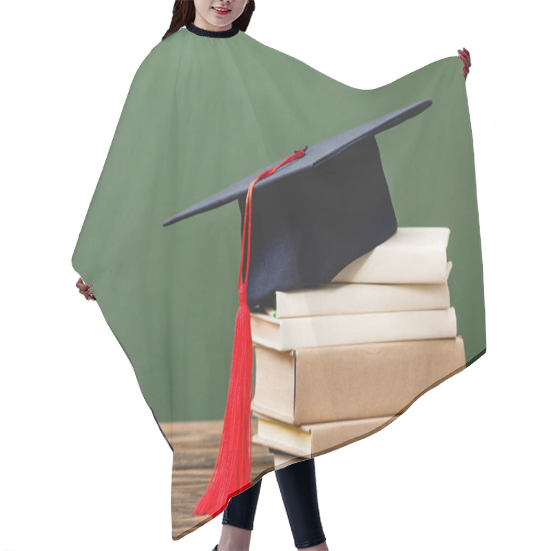 Personality  Books And Academic Cap On Wooden Surface Isolated On Green Hair Cutting Cape