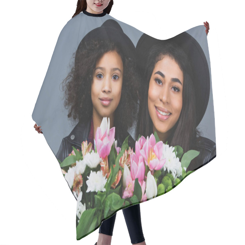 Personality  Close-up Portrait Of Mother And Daughter With Beautiful Bouquets Isolated On Grey Hair Cutting Cape