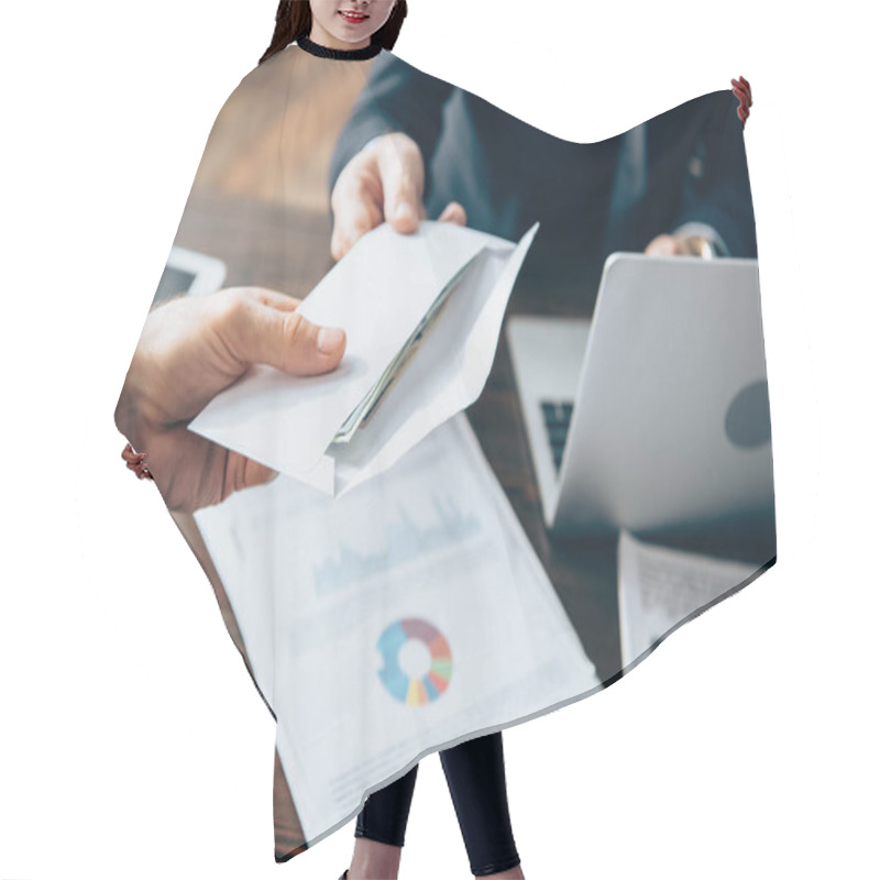 Personality  Cropped View Of Businessman Taking Envelope With Money From Investor Near Papers And Laptop On Blurred Background  Hair Cutting Cape